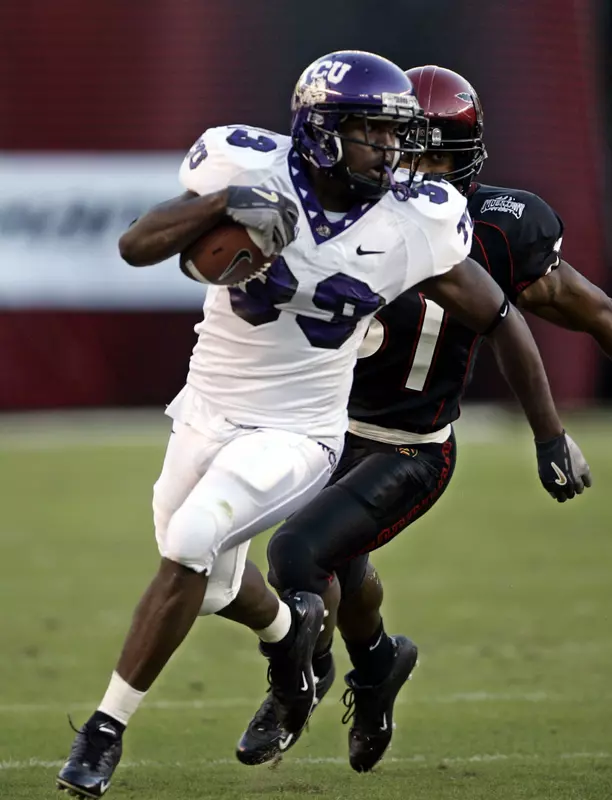 TCU's Robert Merrill outruns San Diego State's Reggie Grigsby on a 39-yard gain to the Aztec 1-yard line in the first quarter of their game Saturday in San Diego. (AP Photo/Lenny Ignelzi)