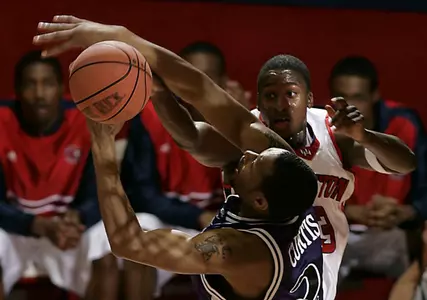 Houston's Lanny Smith, rear, and Texas Christian's Aaron Curtis jump for a rebound. (AP Photo/Houston Chronicle, James Nielsen)