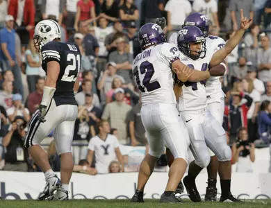 TCU kicker Chris Manfredini (44) celebrates with Reeves Dalton (12) after kicking the winning field goal to beat Brigham Young in overtime. (AP Photo/Douglas C. Pizac)