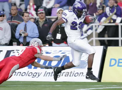 Aaron Brown (23) eludes New Mexico safety Tyson Ditmore to score a touchdown during the second quarter. (AP Photo/Jake Schoellkopf)