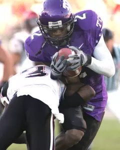 TCU's Donald Massey (2) tucks away a pass reception and runs over San Diego State's Donny Baker (3) for a touchdown in the first quarter. (AP Photo/Fort Worth Star-Telegram, Ron Jenkins)