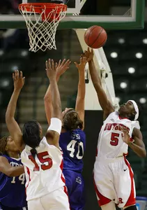Rutgers' Essence Carson (5) blocks a shot by TCU's Jenna Lohse (40). TCU's Lorie Butler-Rayford (14) and Rutgers' Kia Vaughn (15) on right (AP Photo/Tim Larsen)