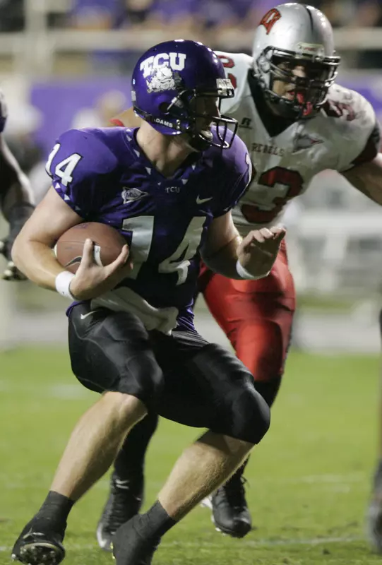Andy Dalton (14) scrambles with the ball as UNLV defensive lineman Malo Taumua chases him in the first quarter. (AP Photo/Donna McWilliam)