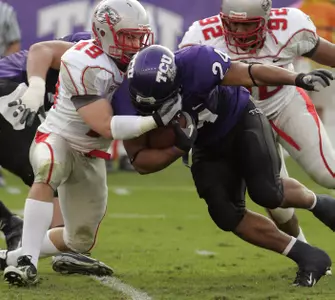 TCU tailback Joseph Turner powers through an attempted tackle in the first quarter. (AP Photo/Donna McWilliam)