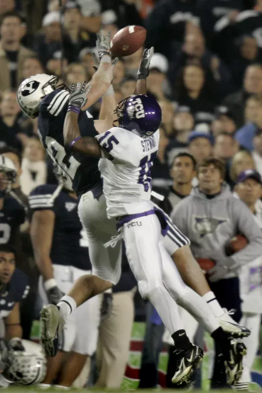 Brigham Young tight end Dennis Pitta (32) pulls in a 32-yard pass for a first down against TCU cornerback Torrey Stewart (15) during the first quarter. (AP Photo/Douglas C. Pizac)