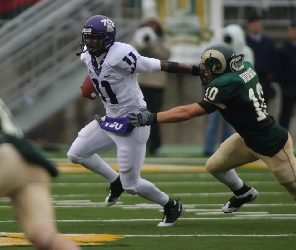 Quarterback Marcus Jackson escapes the grasp of a Colorado State player in Saturday's game.