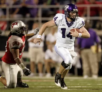 TCU quarterback Andy Dalton carries the ball during the first half. (AP Photo/Louie Traub)