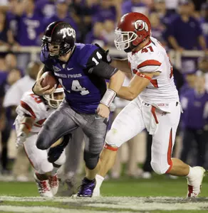 Andy Dalton runs for a gain of 12 yards against Utah defensive back R.J. Stanford and defensive end Koa Misi.