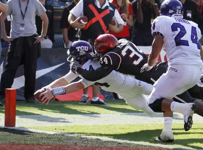 Andy Dalton dives for the pylon while scoring on a 7-yard touchdown run with San Diego State linebacker Jerry Milling on his back.