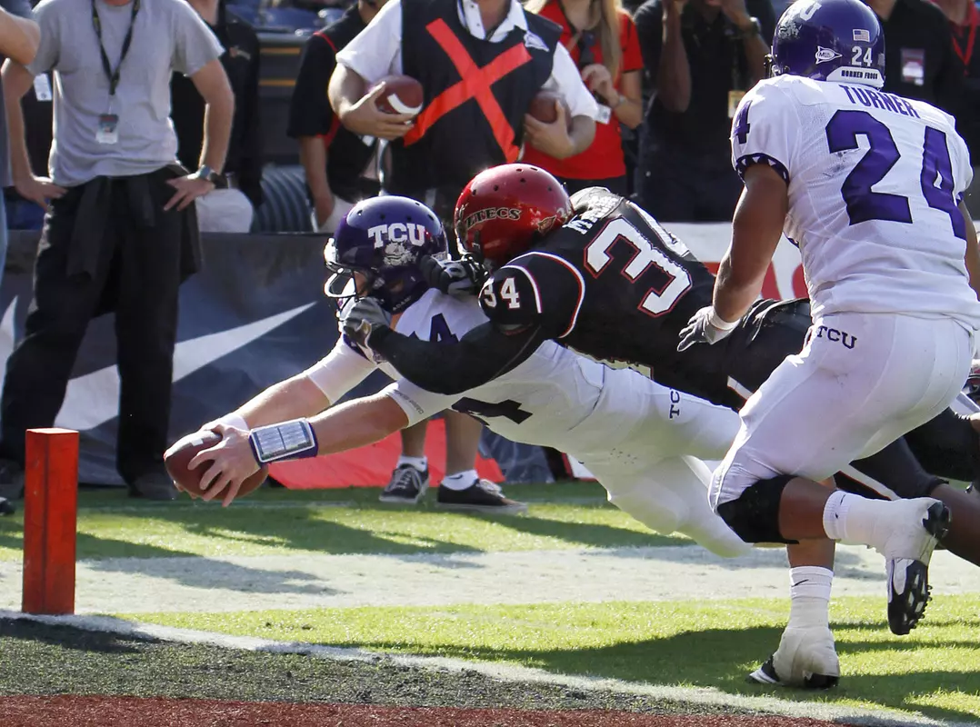 Andy Dalton dives for the pylon while scoring on a 7-yard touchdown run with San Diego State linebacker Jerry Milling on his back.