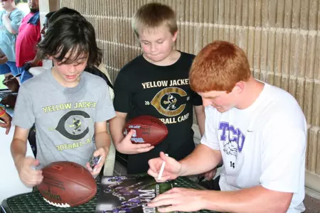 TCU quarterback Andy Dalton signs an autograph in Cleburne.