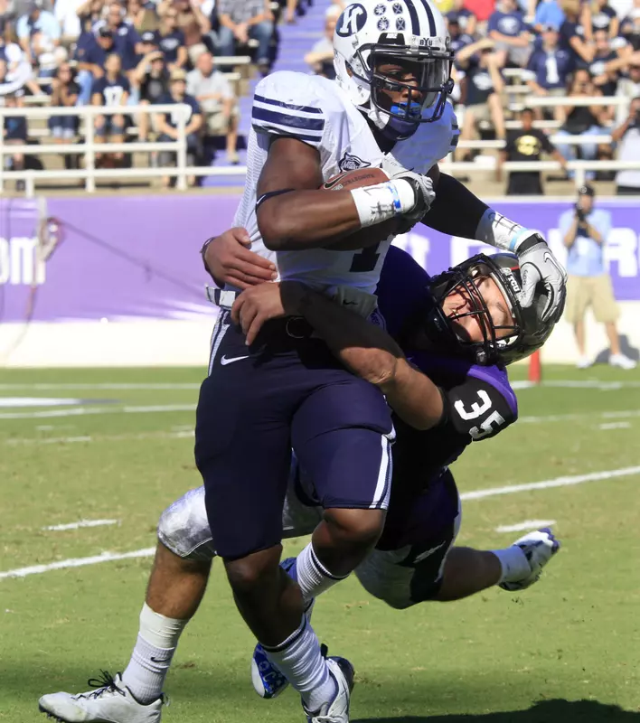 BYU wide receiver O'Neill Chambers, left, is tackled by Tanner Brock.