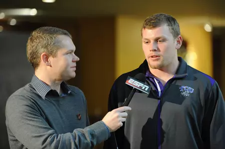 Colin Jones meets with a member of the media.