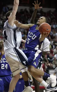 TCU's Ronnie Moss shoots over BYU's Noah Hartsock.