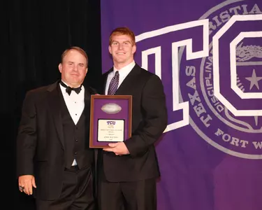 Andy Dalton received his TCU Offensive Most Valuable Player award from head coach Gary Patterson at Saturday night's banquet in the Daniel-Meyer Coliseum.