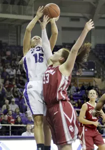 TCU guard Emily Carter (15) takes a shot against Oklahoma center Joanna McFarland (53) during the second half