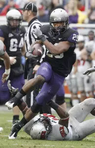 TCU running back Matthew Tucker (29) steps over UNLV linebacker Princeton Jackson (40) and gets past the rest of the Rebels defensive line to score a touchdown in the first half.