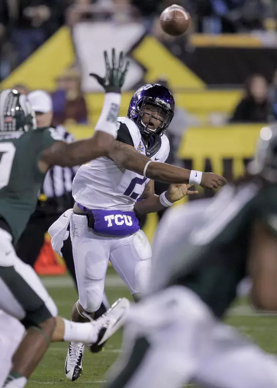 Trevone Boykin (2) delivers a pass against Michigan State during the first half. (AP Photo/Matt York)