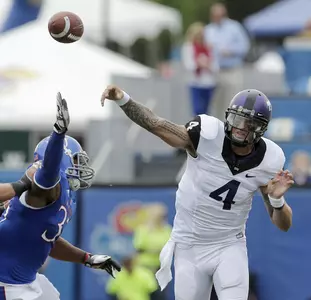 TCU quarterback Casey Pachall (4) passes under pressure from Kansas cornerback Dexter Linton (23). (AP Photo/Charlie Riedel)