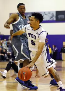 Kyan Anderson dribbles around Tennessee State Tigers guard Charles Tucker.
