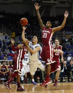 Kyan Anderson (5) shoots past Oklahoma Sooners forward Cameron Clark (21). (Kevin Jairaj-USA TODAY Sports)
