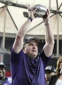 Gary Patterson holding the Chick-fil-A Peach Bowl trophy after TCU's 42-3 win over Ole Miss.