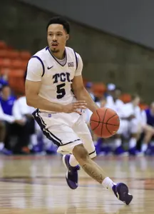 Kyan Anderson dribbles against the Kansas State Wildcats.