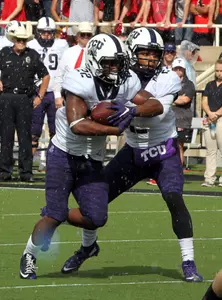 Trevor Boykin hands the ball off to running back Aaron Green.