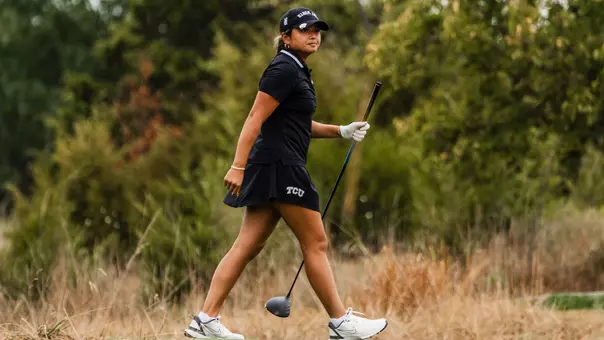Kirstin Angosta departs the tee box holding her driver shaft as she tracks her ball