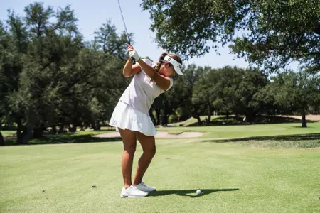 Kirstin Angosta progresses through her back swing wearing a lavender shirt