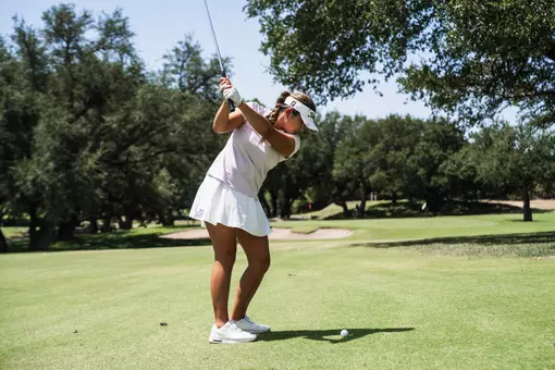 Kirstin Angosta progresses through her back swing wearing a lavender shirt