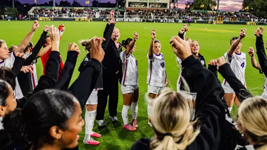 TCU women's soccer team doing Frog sign