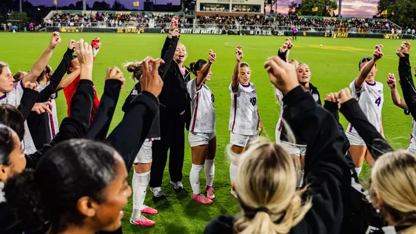 TCU women's soccer team doing Frog sign