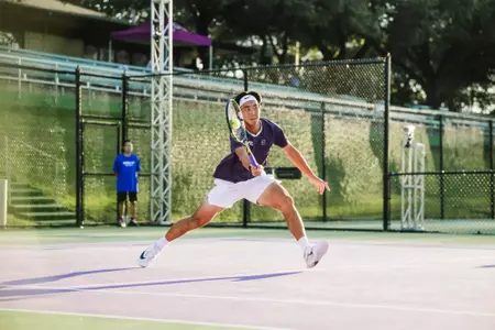Duncan Chan approaching the net, making contact with the ball on his forehand volley