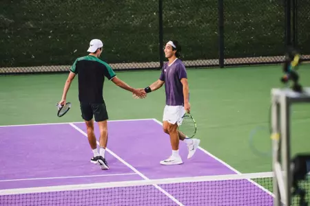 Duncan Chan and Oliver Bonding smiling and high-fiving in doubles