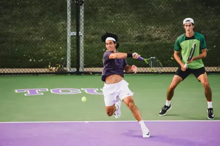 Duncan Chan finishing his swing after ripping a forehand