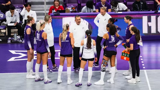 Volleyball team huddle against Kansas