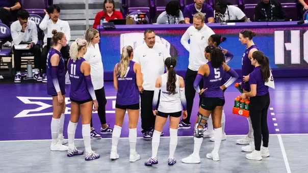 Volleyball team huddle against Kansas