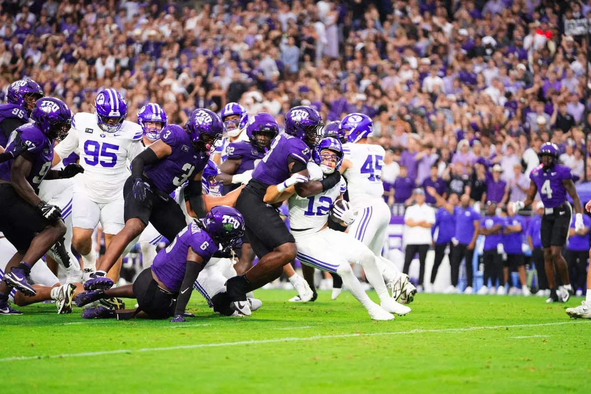 TCU's defense swarms the BYU runner.