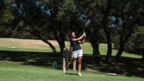 Ella Forss follows through on a tee shot wearing a black polo