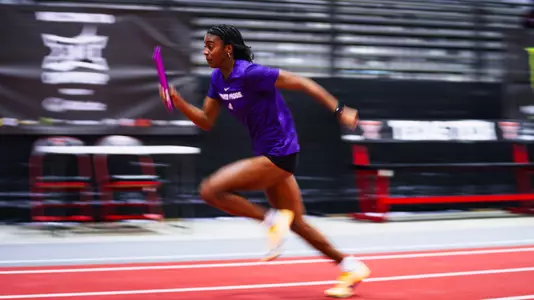 Motion blurred photo of Laila Smith running down the track