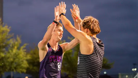 Zach Troutman and CJ Meyer high-five after the 5000m race