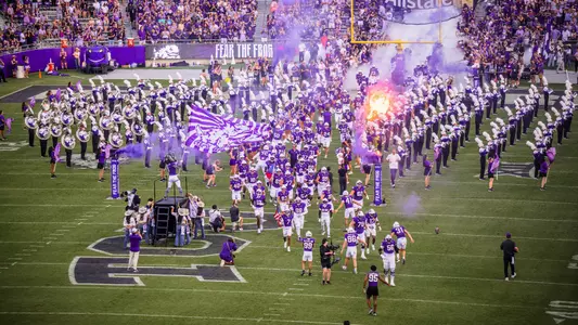 TCU football team running out of the tunnel before its game against Abilene Christian