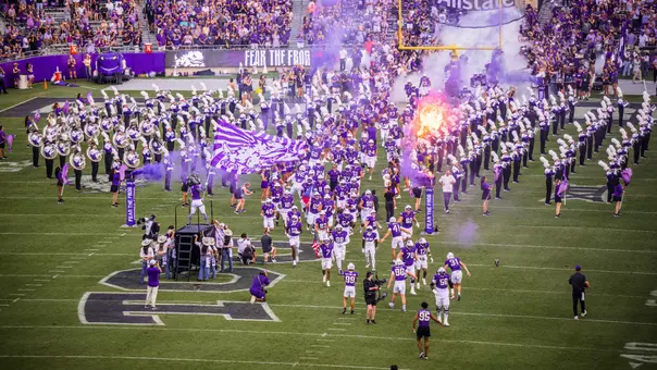 TCU football team running out of the tunnel before its game against Abilene Christian