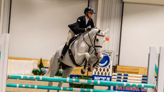 Lex Lipacis jumping over a fence at the NCEA Championships