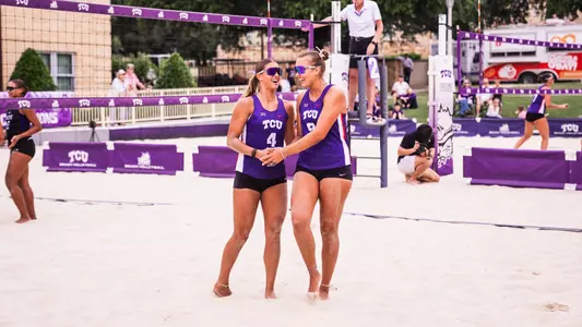 Grace Townson and Olivia Clines embracing on a beach volleyball court