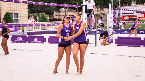 Grace Townson and Olivia Clines embracing on a beach volleyball court