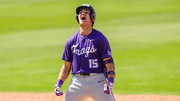 Chase Brunson celebrates his go-ahead, two-run double at second base in a win over Baylor