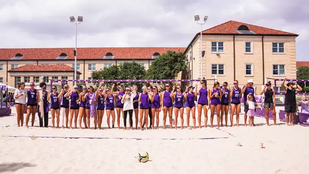 TCU beach volleyball team in a line postgame