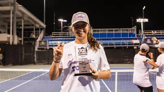 Jennifer Jackson holding Big 12 Tournament Most Outstanding Player Trophy